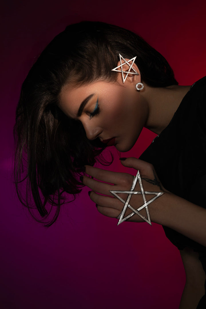 The Mystic Pentagram Earrings, a unique avant-garde statement accessory, is designed to empower dark feminine energy. Ethically handmade of Sterling Silver 925.